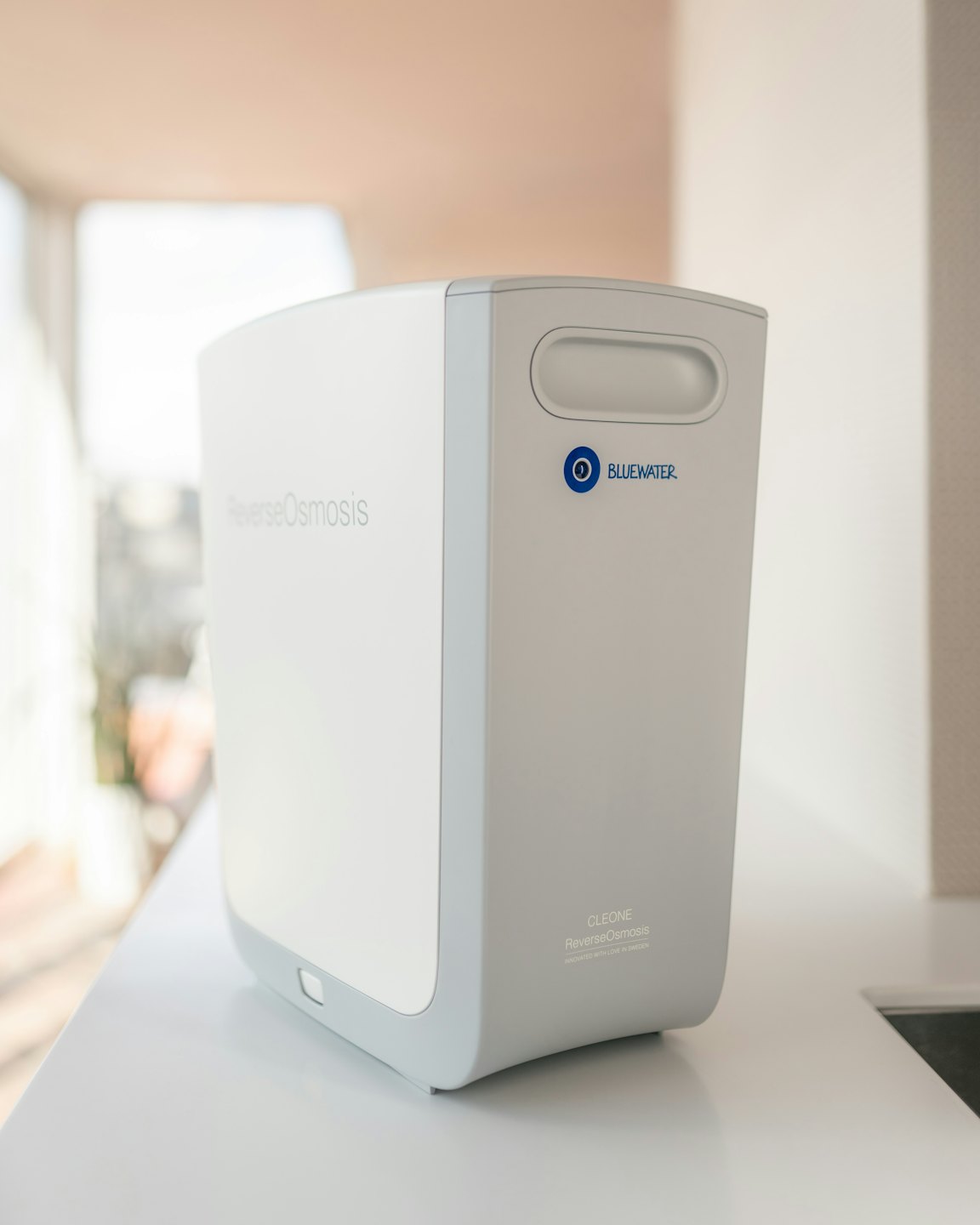White reverse osmosis water filter on a clean countertop.