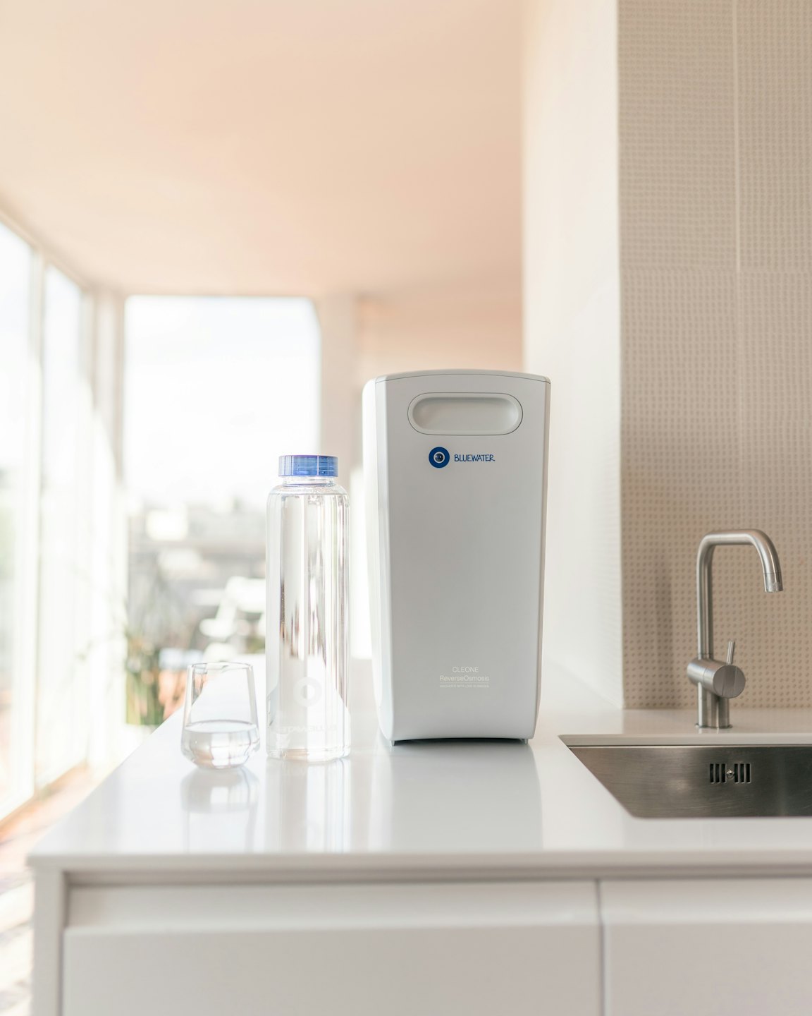 White water filter and bottle on kitchen counter.