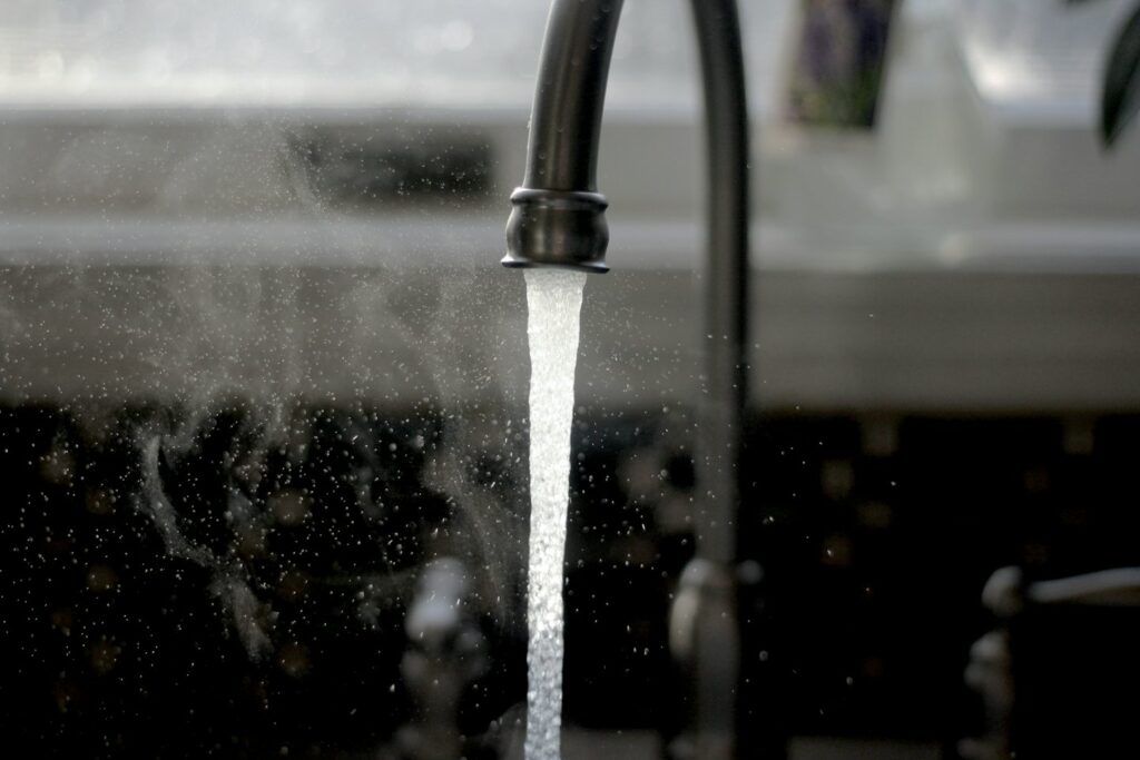 Kitchen faucet with running water.